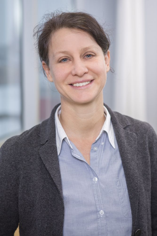 Prof. Dr. med. Angela Abicht, seriös lächelnd, trägt einen dunkelgrauen Blazer über einer blauen Bluse